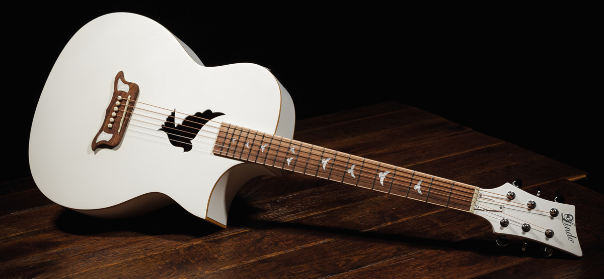 Photo of a White Guitar that is nice to look at A classic White with a Dove Guitar